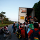 Central American migrants headed to the US border in 2018 climb into the back of a tractor-trailer.
